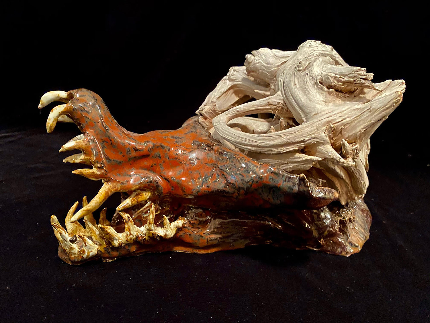 “Wolf Man,” ceramic and wood by Tom Biron.